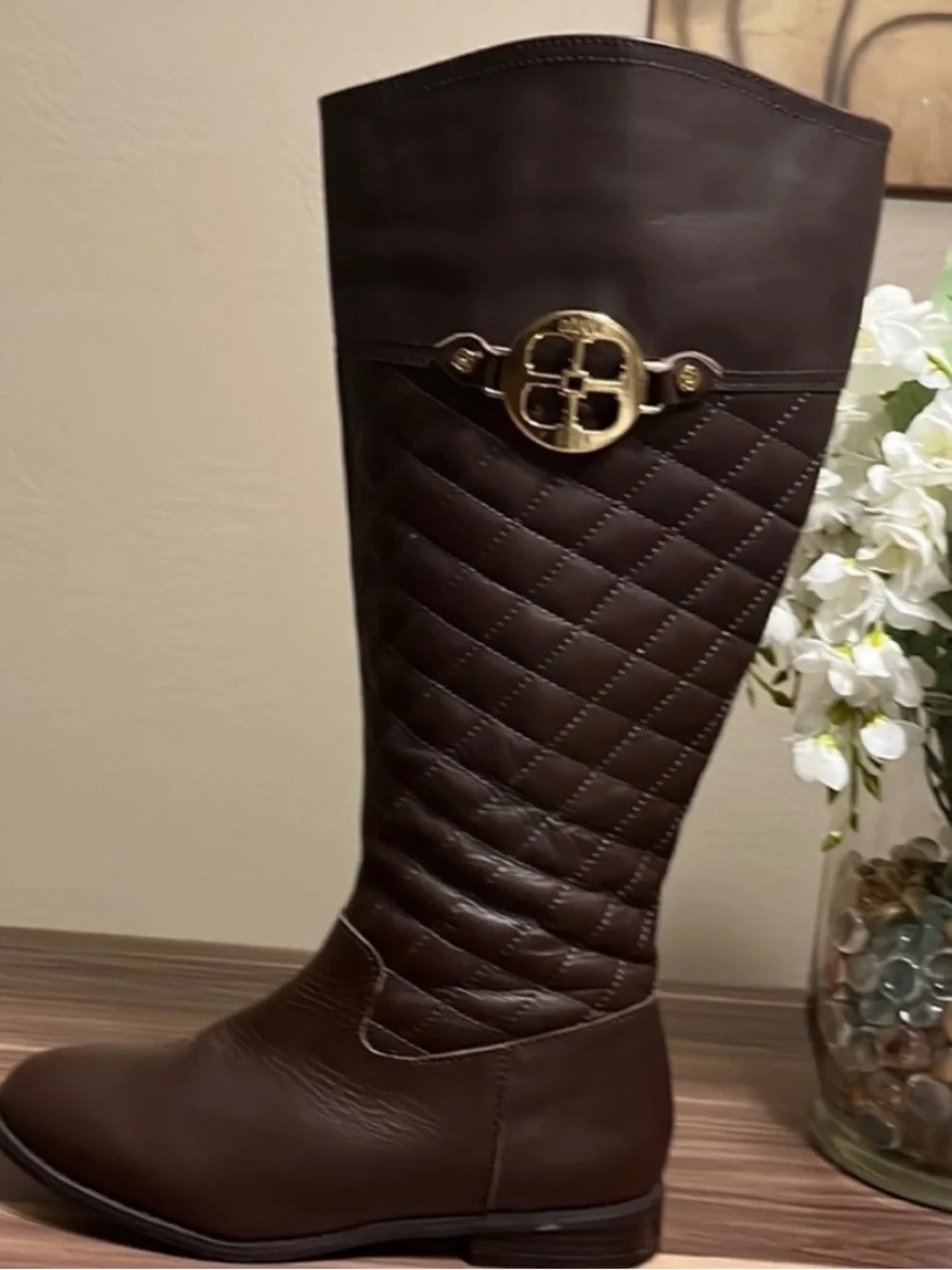 Iman Brown Quilted Knee-High Riding Boots with gold logo medallion